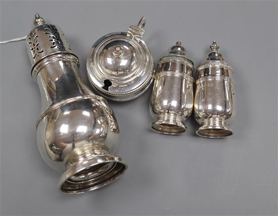 A George V silver sugar caster and a 1930s silver three piece condiment set.